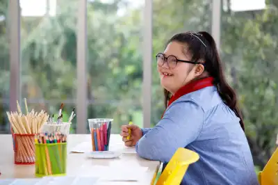 girl smiling working at a table